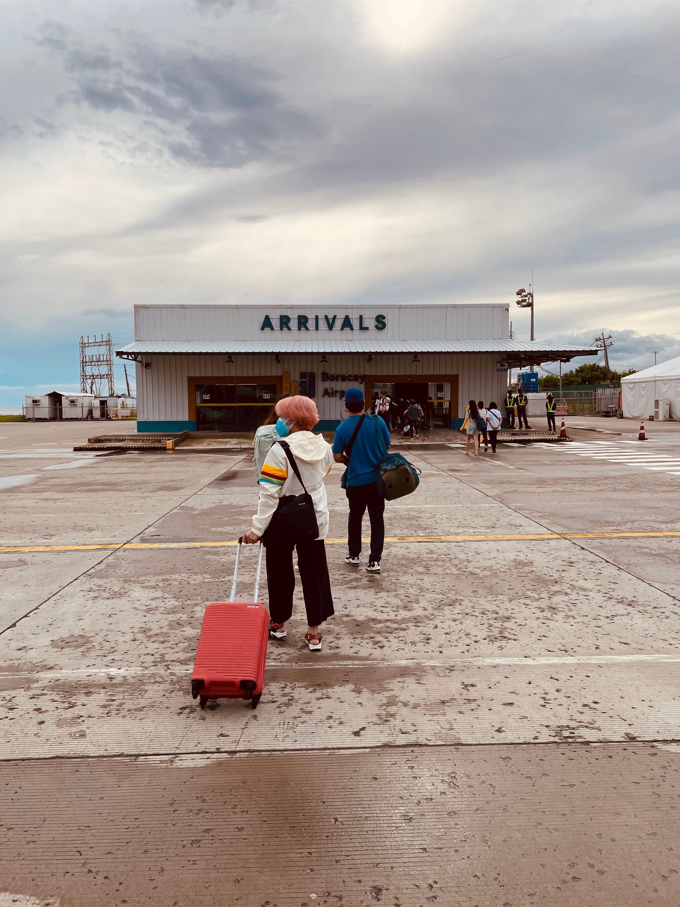 Group travelers arriving together at an airport terminal with luggage